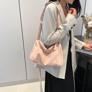 Pink waterproof nylon crossbody tote bag for women showing casual commuter style