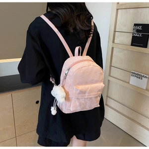 Detailed back view of pink mini backpack with marble texture and white cloud charm