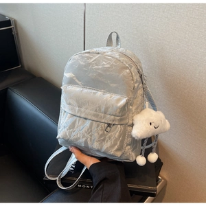 Silver-gray backpack with crinkle texture featuring a white cloud plush charm and front pocket