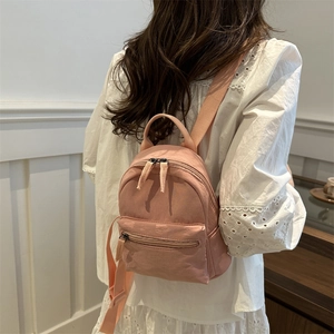 Minimalist pink mini backpack for women featuring waterproof nylon and adjustable straps
