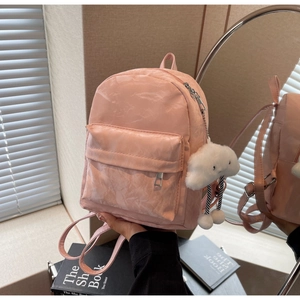 Close-up of pink crinkled texture backpack featuring a white plush cloud pendant detail
