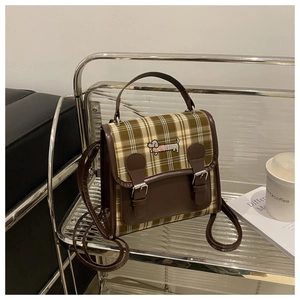 Detail of vintage plaid backpack with dachshund embroidery and dual-strap versatility