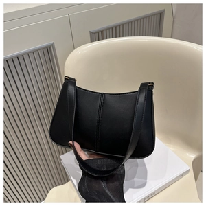 Detail view of the black matte faux leather hobo bag featuring vertical decorative stitching