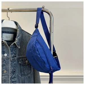Detail view of Klein blue canvas crossbody bag with adjustable wide strap and zipper