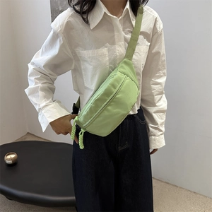 Minimalist light green nylon waist bag for women with adjustable strap and woven zipper pull