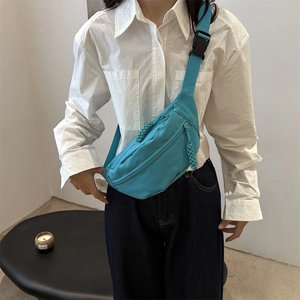 Minimalist lake blue nylon crossbody chest bag with adjustable strap and woven zippers