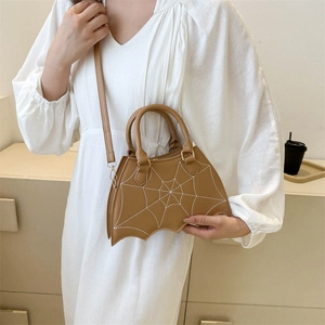 Brown bat-shaped handbag with white spider web stitching and crossbody strap