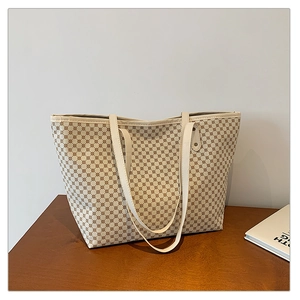 Detail of retro cream leather tote bag with brown geometric circular grid pattern