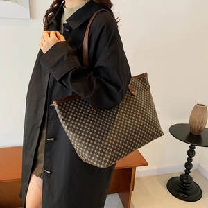 Brown vintage pattern large tote bag with top handles shown on model shoulder