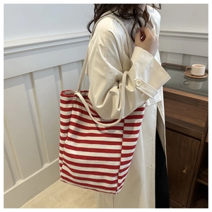 Détail du grand sac cabas en toile à rayures rouges et blanches avec des anses en corde