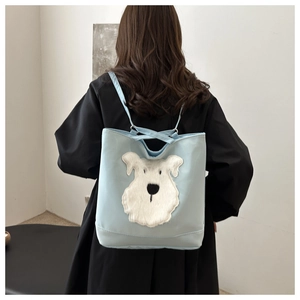 Detail of light blue tote bag featuring white plush puppy patch embroidery