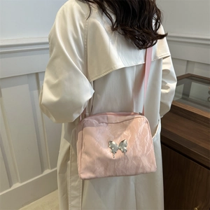 Pink pillow shoulder bag with silver butterfly charm and chain strap for women