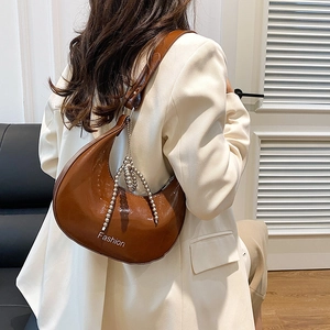 Brown patent leather crescent shoulder bag with silver bead chain and Fashion print