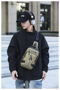 Detail of olive green multi-pocket chest bag for men showing durable nylon texture and zippers