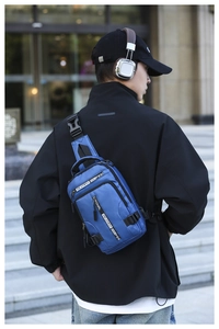 Detail of blue nylon sling bag for men with multi-zipper structure and branded webbing strap