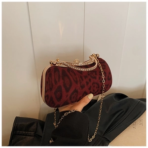 Detail der burgunderroten Clutch mit Leopardenmuster, Goldrahmen und Diamantverschluss