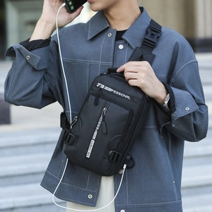 Men's tactical crossbody bag in black nylon with multiple zip compartments and charging port