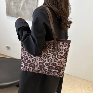 Classic leopard print tote bag with brown leather straps shown on a model for daily use