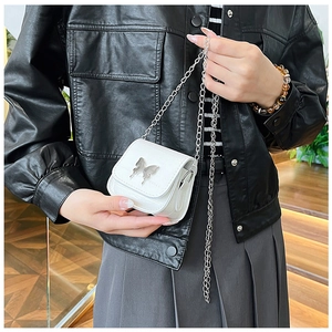 Detail of white mini crossbody bag featuring a silver butterfly clasp and metal chain
