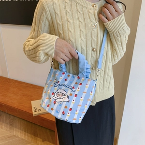 Cute light blue striped canvas bucket bag featuring sheep print and adjustable strap