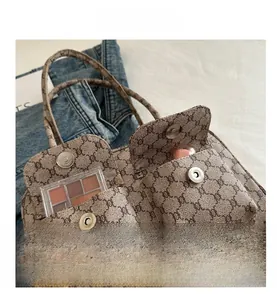 Macro view of vintage beige print shoulder bag showing front pockets and storage capacity