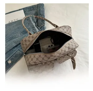 Internal capacity view of a vintage monogram Boston bag with daily essentials inside