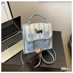 Detail of light blue striped backpack with puppy embroidery and dual leather straps