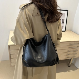 Minimalist black leather tote bag with embossed logo for women's daily commute