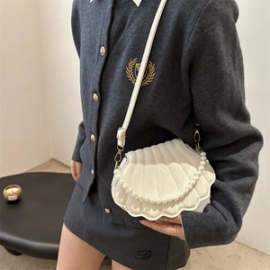 White quilted shell-shaped shoulder bag with pearl chain and gold hardware for women