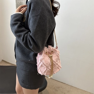 Pink denim quilted drawstring bucket bag with gold chain strap and pearl details