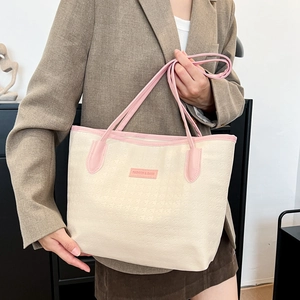 Minimalist beige textured tote bag with pink straps for daily commuting and college students