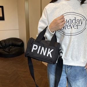 Sac de sport cylindrique noir en nylon avec lettrage PINK et bandoulière réglable