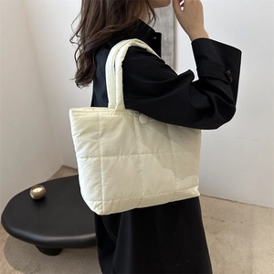 Quilted beige underarm tote bag in lightweight nylon with padded cloud texture