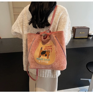 Pink corduroy tote bag featuring cat embroidery and decorative zipper detail