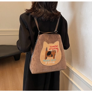 Detail of a brown corduroy tote bag featuring a cute cat embroidery on the front panel