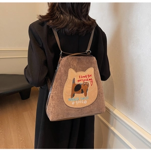 Close-up of brown corduroy tote bag with cat embroidery and comfortable shoulder strap