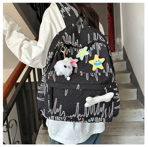 Detailed back view of black backpack with colorful wavy patterns and cute star charms