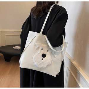 Close-up of a white PU leather tote bag featuring a 3D plush Schnauzer puppy patch