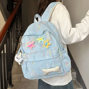 Cute light blue school backpack with star patches and textured embroidery design