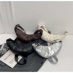 Minimalist croissant bags in four colors showing quilted details and wide shoulder straps