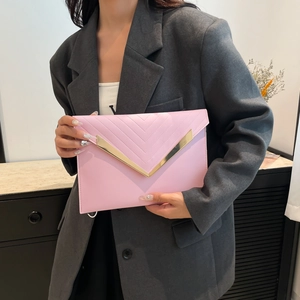 Pink quilted leather envelope clutch bag with gold V-shaped trim and minimalist design