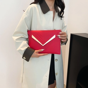 Minimalist red envelope clutch bag with gold V-shaped metal hardware and embossed details
