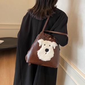 Brown leather tote bag featuring a cute white plush schnauzer puppy design for women