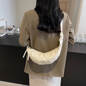 Minimalist white pleated dumpling bag with adjustable shoulder strap and knot detail