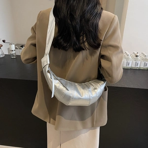 Silver crescent crossbody bag with metallic faux leather texture and stitch detailing