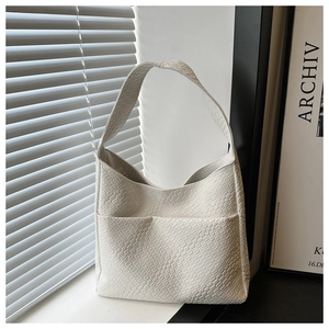Detail view of large white tote bag with woven texture on a window sill scene