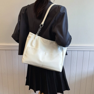Minimalist white large capacity faux leather tote bag with stylish metal chain strap detail