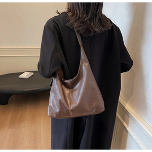 Detail view of large dark brown retro faux leather hobo bag with vintage pleated texture