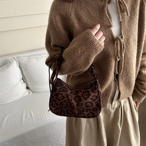 Fashionable leopard print crescent shoulder bag with unique knot strap detail for women
