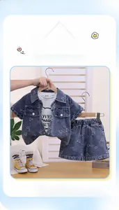 Detail view of denim infant outfit with cartoon bear pattern shirt and matching shorts